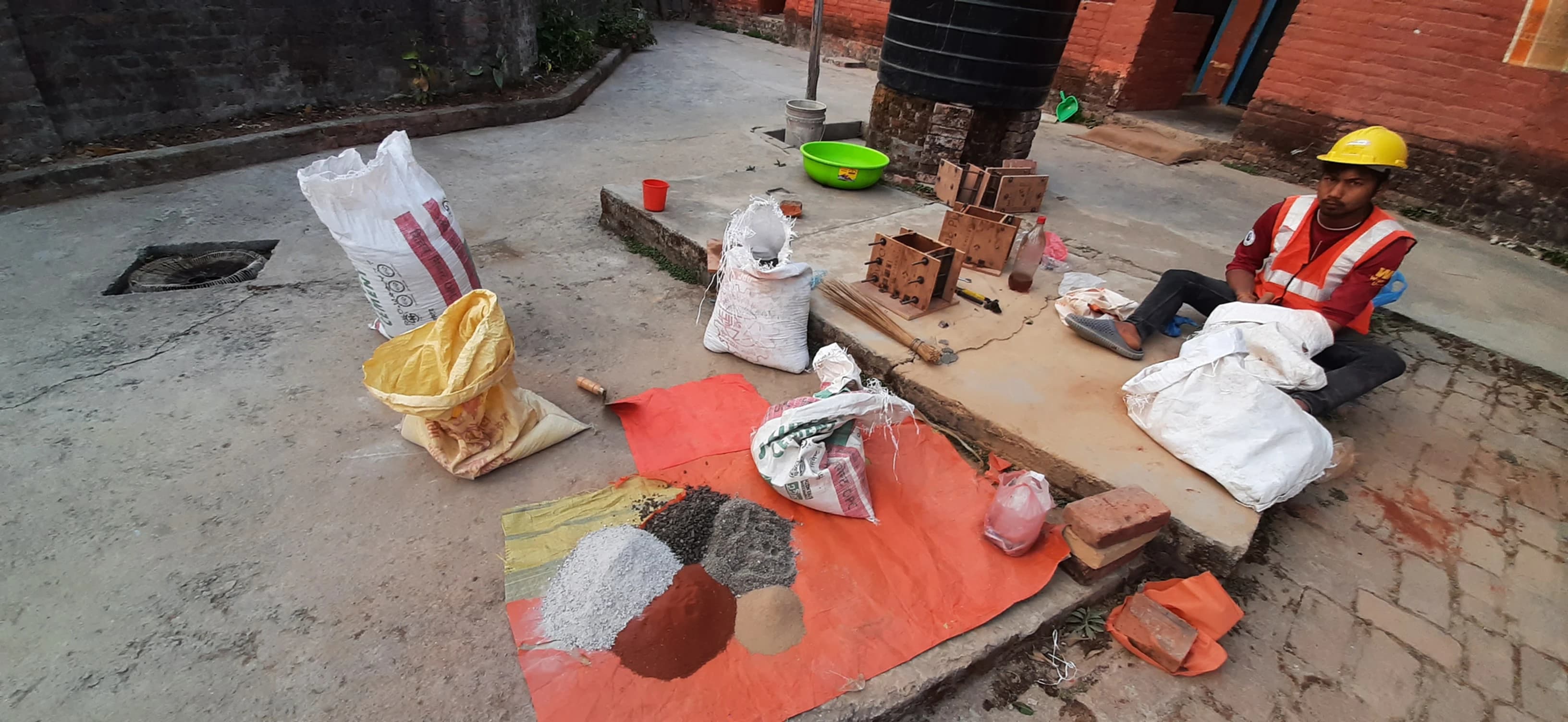 Trials and preparation for rammed earth works